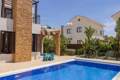 a villa with a swimming pool and a house at Ayia Napa Luxury Seaside Villa Ionion H15 in Ayia Napa