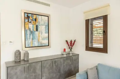 a living room with a couch and a picture on the wall at Ayia Napa Luxury Seaside Villa Ionion H15 in Ayia Napa