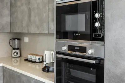 a kitchen with a microwave and a coffee maker at Ayia Napa Luxury Seaside Villa Ionion H15 in Ayia Napa