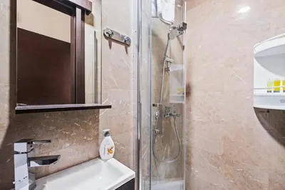 a bathroom with a shower and a sink at Downtown Finikoudes Beach Apartment in Larnaka