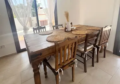 a dining room table with chairs and a wooden table and chairsktop at Eros Villa-Private Luxury Estate in Pissouri