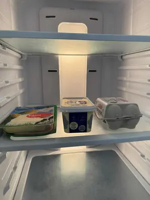 an open refrigerator with food items on a shelf at Eros Villa-Private Luxury Estate in Pissouri