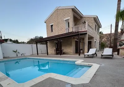 a swimming pool in front of a house at Eros Villa-Private Luxury Estate in Pissouri
