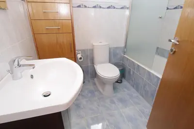 a bathroom with a toilet and a sink and a shower at Maouris Villa in Protaras