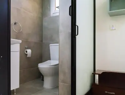 a bathroom with a toilet and a sink at Central Cosy Comfort Suite in Nicosia