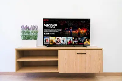 a tv sitting on top of a wooden entertainment center at Central Cosy Comfort Suite in Nicosia