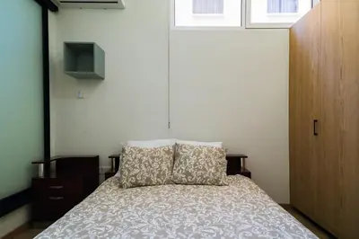 a bedroom with a bed with a pillow and a window at Central Cosy Comfort Suite in Nicosia