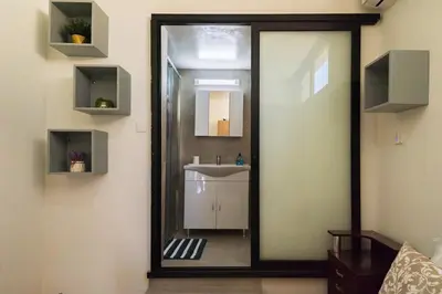 a bathroom with a mirror and a sink at Central Cosy Comfort Suite in Nicosia
