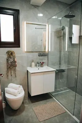 a bathroom with a shower and a toilet and a sink at Villa Lela in Paralimni
