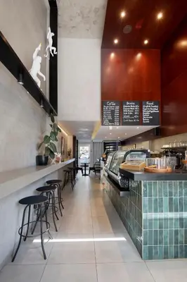 a restaurant with a bar with stools and tables at Urban Condo 10th Floor - 2 Bdr in Nicosia