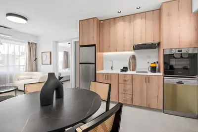 a kitchen and dining room with a black table at Finikoudes Marina View 102 in Larnaka