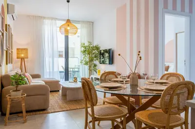 a living room with a table and chairs at Lunette - Artful 1-BR Apartment & Balcony in Larnaca in Larnaka