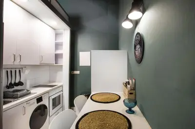 a kitchen with a counter with a washer and dryer at Atelier Residences by Sweet Keys in Limassol