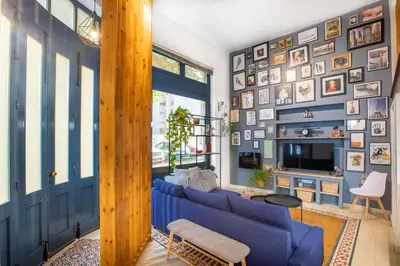 a living room with a blue couch and a tv at Atelier Residences by Sweet Keys in Limassol