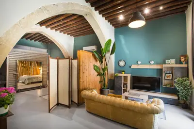 a living room with a couch and a fireplace at Atelier Residences by Sweet Keys in Limassol