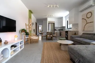 a living room with a couch and a table at Solenne - Stylish 2-BR Apartment & Balcony in Larnaca in Larnaka