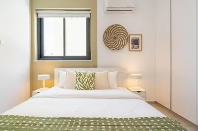 a bedroom with a large white bed and a window at Solenne - Stylish 2-BR Apartment & Balcony in Larnaca in Larnaka