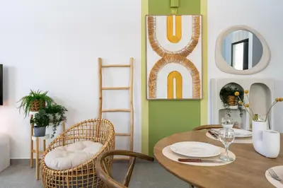 a dining room with a wooden table and chairs at Solenne - Stylish 2-BR Apartment & Balcony in Larnaca in Larnaka