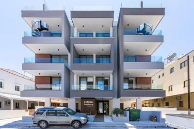 a car parked in a parking lot in front of a building at Solenne - Stylish 2-BR Apartment & Balcony in Larnaca in Larnaka