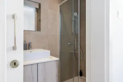 a bathroom with a sink and a shower at Solenne - Stylish 2-BR Apartment & Balcony in Larnaca in Larnaka