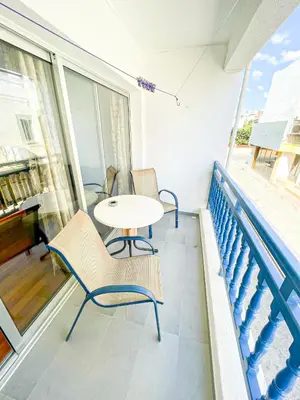 a patio with a table and chairs on a balcony at Awaken Your Hidden Goddess Retreat at Nissi Avenue - Central Ayia Napa in Ayia Napa