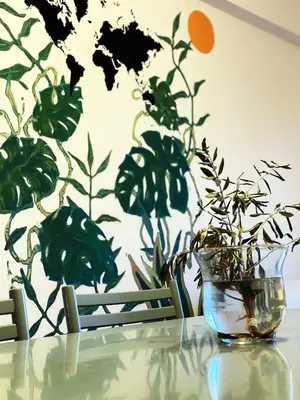 a glass vase sitting on a table with a plant at Lima Sol House in Limassol