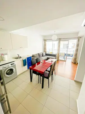 a kitchen and living room with a red table and chairs at Awaken Your Divine Self Sacred Self Discovery Retreat in Ayia Napa Cyprus in Ayia Napa
