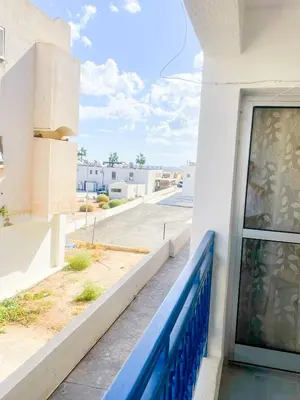 a balcony of a building with a blue railing at Awaken Your Divine Self Sacred Self Discovery Retreat in Ayia Napa Cyprus in Ayia Napa