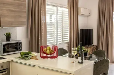 a kitchen with a table with a bowl of fruit on it at Larnaca Seaside Villa Marina 43 in Pervolia