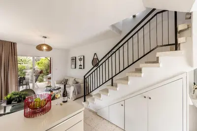 a kitchen and living room with white walls and stairs at Larnaca Seaside Villa Marina 43 in Pervolia