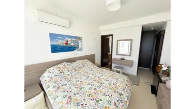 a bedroom with a bed with a colorful bedspread at Bow Villa in Paralimni