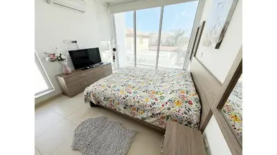 a bedroom with a bed and a tv in it at Bow Villa in Paralimni