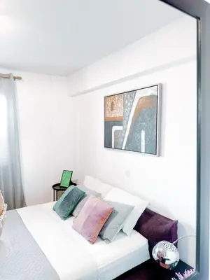 a bedroom with a white bed with pillows on it at Ikarus in Limassol
