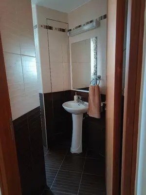 a small bathroom with a sink and a mirror at Marina City Centre Stays in Larnaka