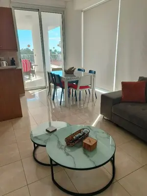 a living room with a couch and a table at Marina City Centre Stays in Larnaka