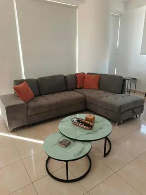 a living room with a couch and two tables at Marina City Centre Stays in Larnaka