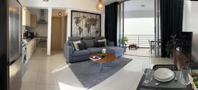 a living room with a couch and a table at Makriev Suite in Larnaka