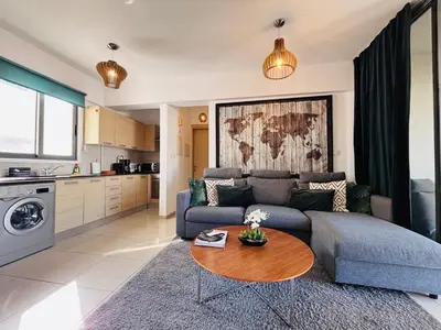 a living room with a couch and a table at Makriev Suite in Larnaka