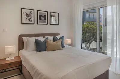 a bedroom with a large bed and a window at Phaedrus Living Travertine Residences 101 in Strovolos