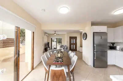 a kitchen and dining room with a table and chairs at Villa Poseidon in Paralimni