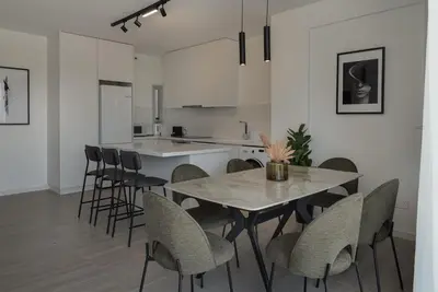 a kitchen and dining room with a table and chairs at Phaedrus Living Travertine Residences 102 in Strovolos