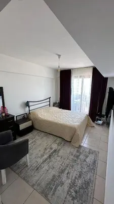 a bedroom with a bed and a large rug at Kyrenia 2 bedroom apartment in Ayios Dhometios