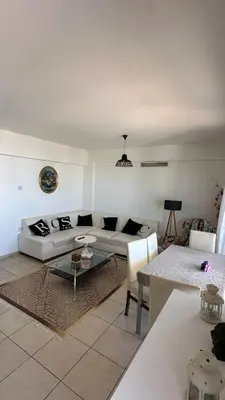 a living room with a couch and a table at Kyrenia 2 bedroom apartment in Ayios Dhometios