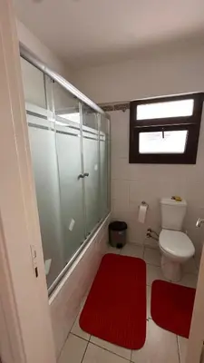 a bathroom with a toilet and a red rug at Kyrenia 2 bedroom apartment in Ayios Dhometios