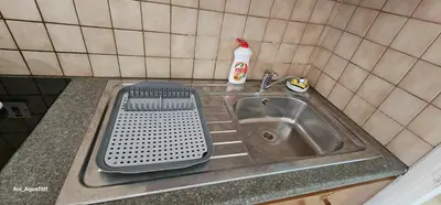 a kitchen sink with a strainer next to it at Pergamonto Apartments in Ayia Napa