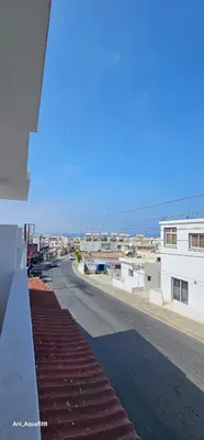 a view of a street with buildings and the ocean at Pergamonto Apartments in Ayia Napa