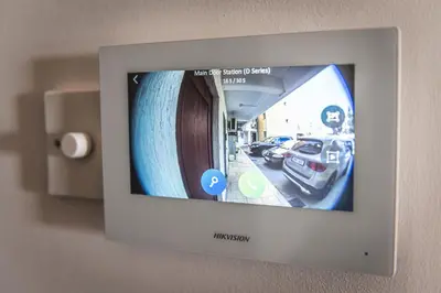 a television on a wall with a picture of a car at Elite Seaside Apartment in Limassol