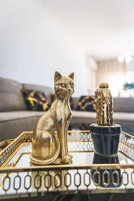 a gold cat statue sitting on a coffee table at Elite Seaside Apartment in Limassol