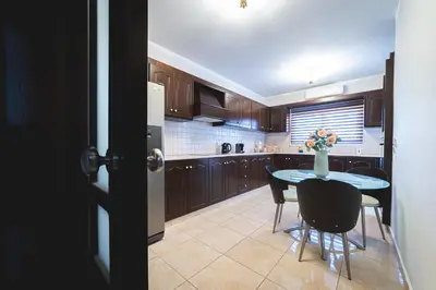 a kitchen with a table with a vase of flowers on it at Elite Seaside Apartment in Limassol