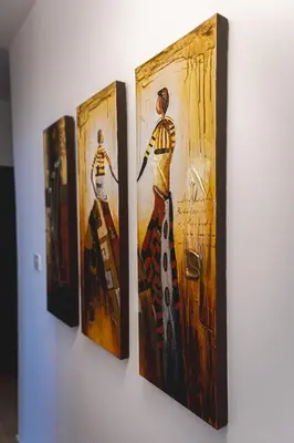 a group of four paintings hanging on a wall at Elite Seaside Apartment in Limassol